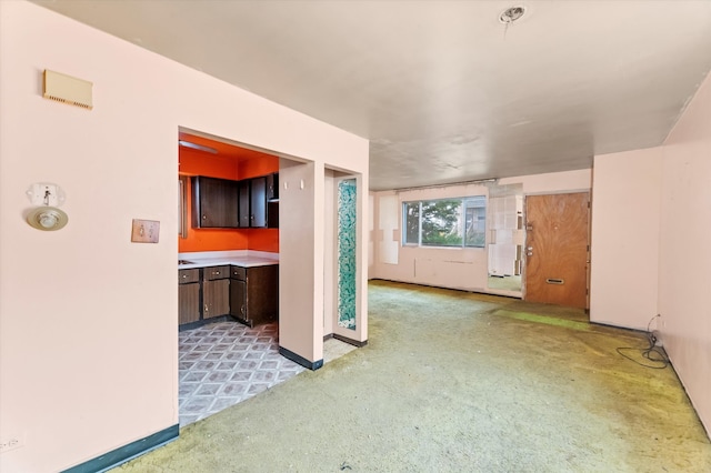 unfurnished living room featuring light colored carpet