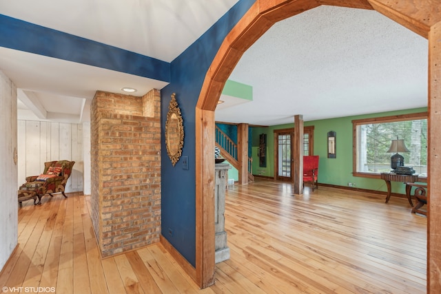 foyer featuring light wood-type flooring and a textured ceiling