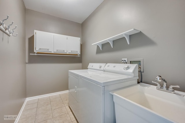 clothes washing area with light tile patterned flooring, independent washer and dryer, sink, and cabinets