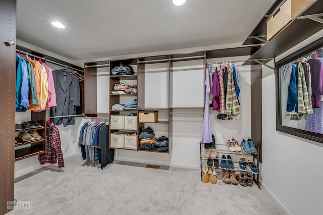 spacious closet featuring light carpet