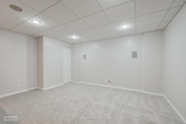 spare room with light carpet and a drop ceiling