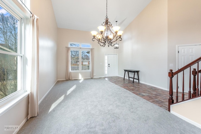 interior space featuring an inviting chandelier and high vaulted ceiling