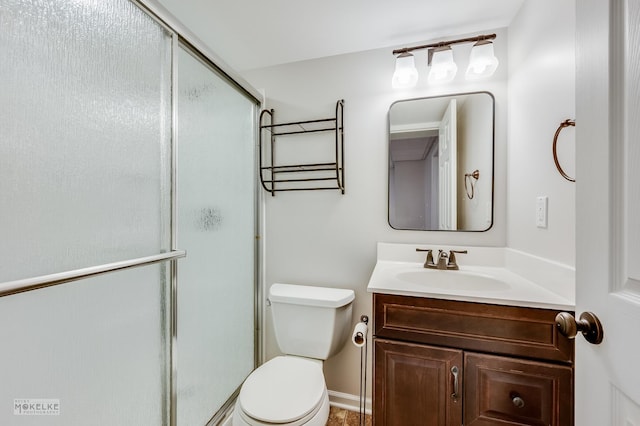 bathroom with vanity, toilet, and an enclosed shower