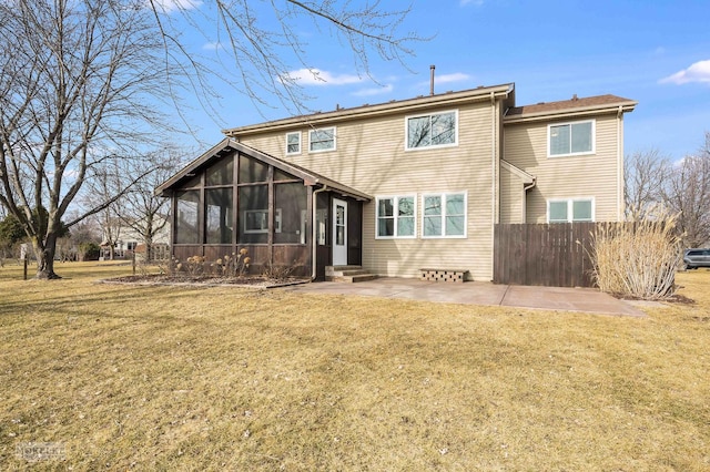 back of property with a lawn, a sunroom, and a patio