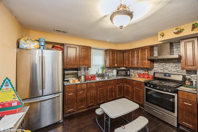 3235 S 50th Ct, Cicero, IL 60804 - kitchen with appliances with stainless steel finishes, wall chimney range hood, decorative backsplash, a sink, and dark wood-style floors