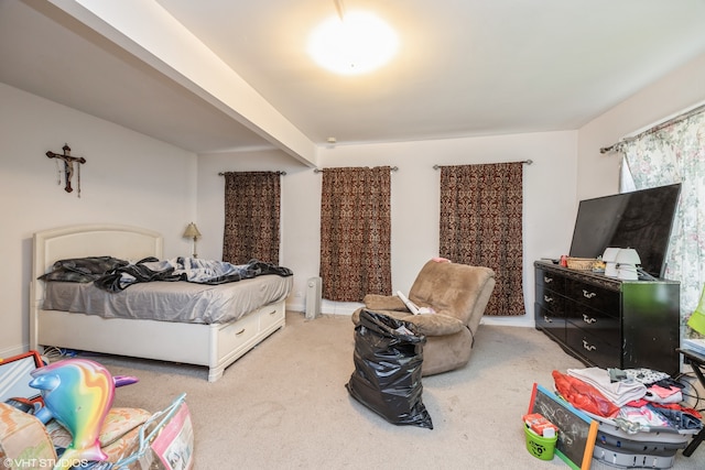 carpeted bedroom featuring beamed ceiling