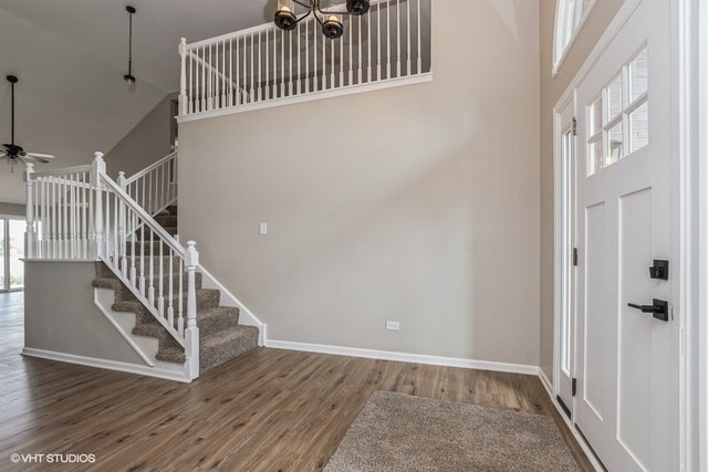 entryway with hardwood / wood-style flooring, high vaulted ceiling, and plenty of natural light