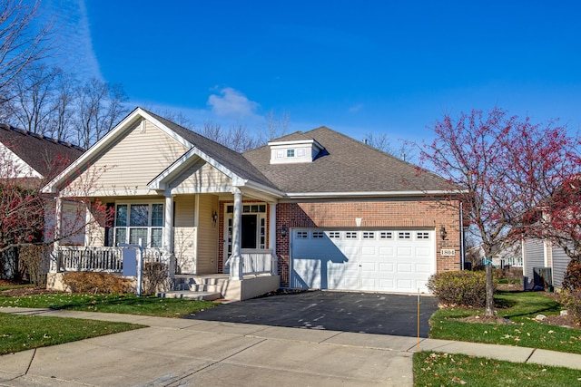 view of front of home featuring a porch and a garage