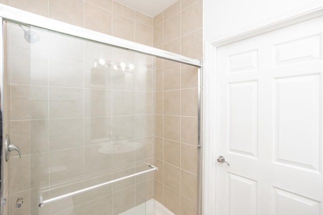 bathroom with a shower with shower door