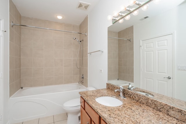 full bathroom with tile patterned flooring, vanity, toilet, and tiled shower / bath