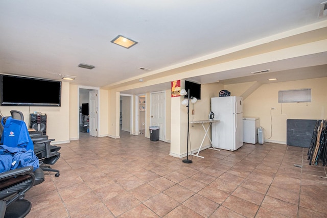 basement with refrigerator and white fridge