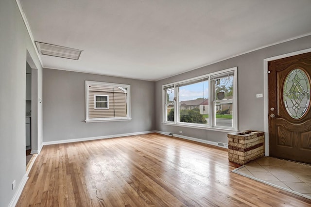 entryway featuring baseboards, visible vents, and wood finished floors