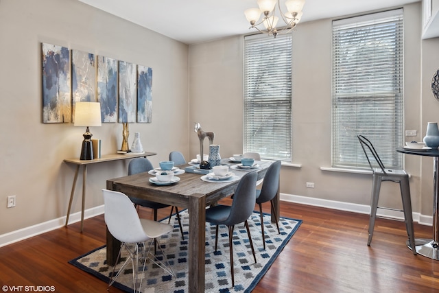 dining area featuring a chandelier, a healthy amount of sunlight, and dark hardwood / wood-style floors