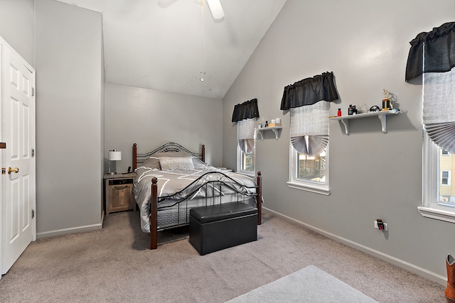 bedroom with ceiling fan, light colored carpet, and vaulted ceiling