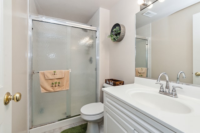 bathroom featuring tile patterned floors, vanity, walk in shower, and toilet