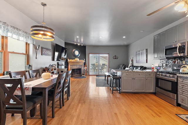 dining space featuring an inviting chandelier and light wood-type flooring