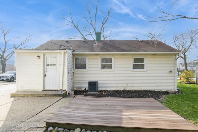 back of property featuring central air condition unit and a deck