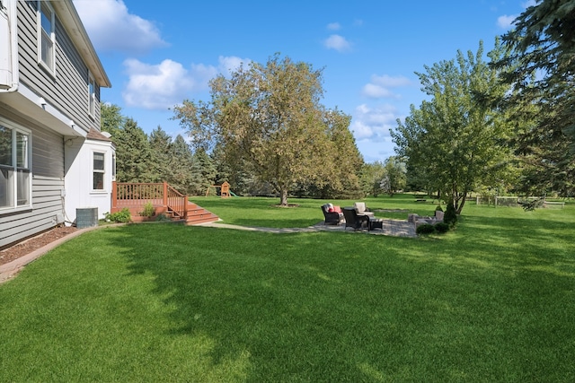 view of yard featuring central air condition unit and a patio area