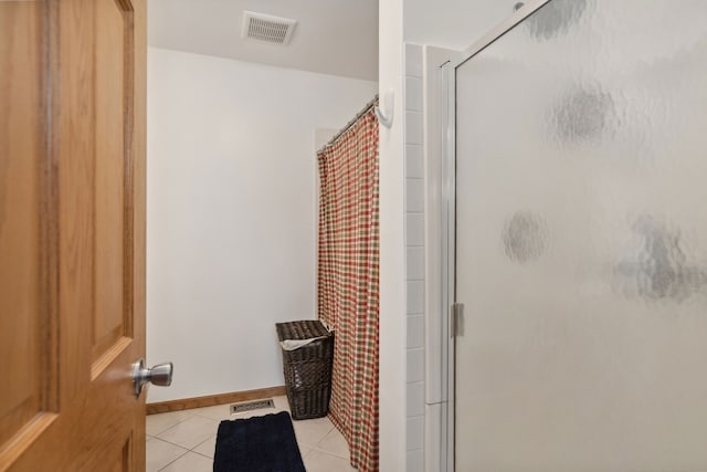 bathroom featuring tile patterned floors and an enclosed shower