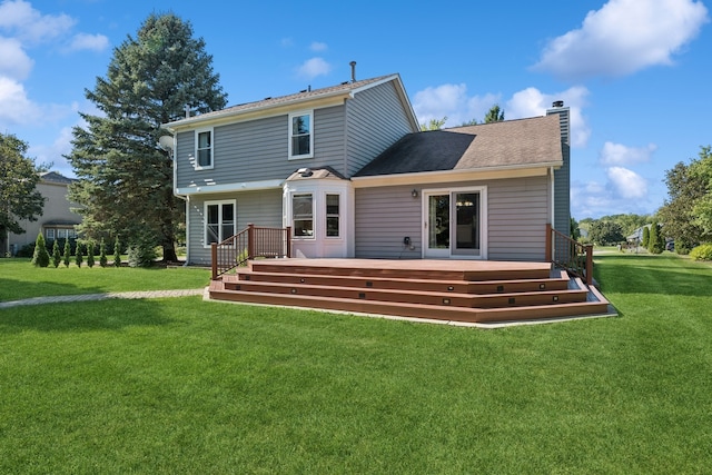 back of house with a lawn and a wooden deck