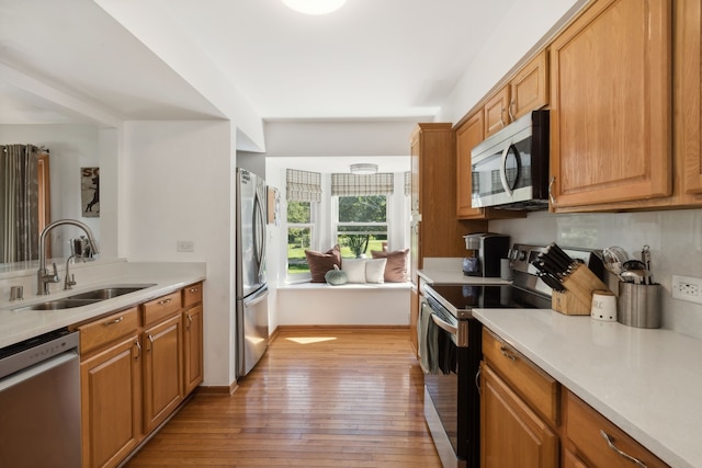 kitchen featuring sink, stainless steel appliances, and light hardwood / wood-style flooring