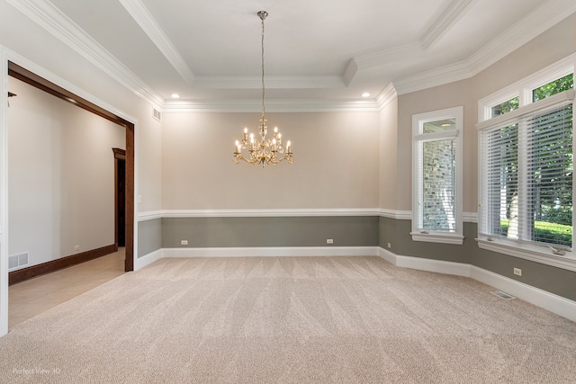 unfurnished room featuring a healthy amount of sunlight, a raised ceiling, and light carpet