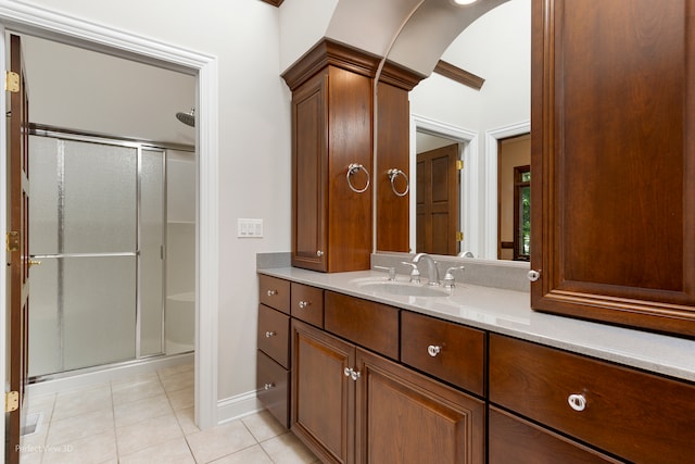 bathroom with vanity, tile patterned floors, and walk in shower