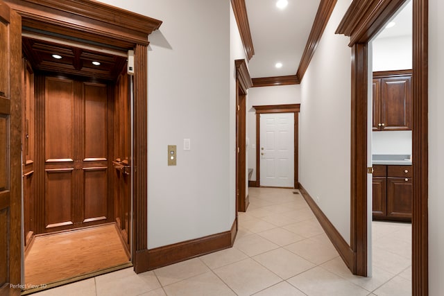 hallway with light tile patterned floors, elevator, and ornamental molding