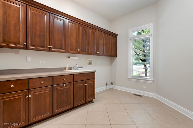 laundry area featuring cabinets, hookup for a washing machine, a wealth of natural light, and sink