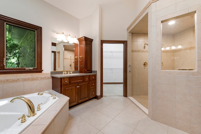 bathroom with tile patterned flooring, vanity, and independent shower and bath