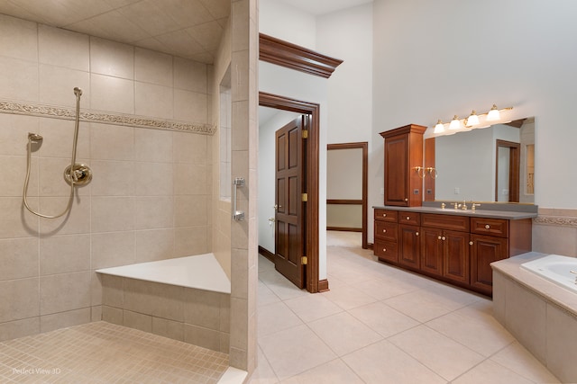 bathroom featuring tile patterned flooring, vanity, and independent shower and bath