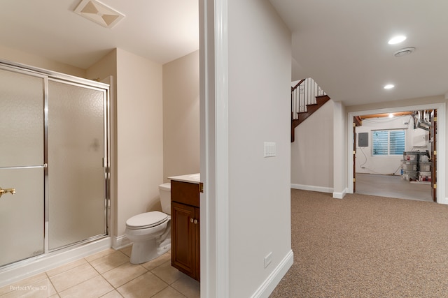 bathroom featuring toilet, tile patterned flooring, vanity, and walk in shower