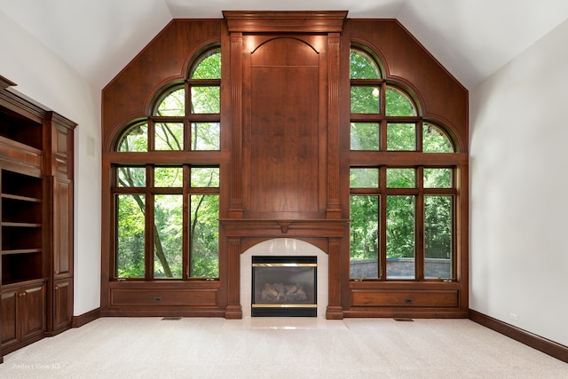 unfurnished living room with plenty of natural light and lofted ceiling