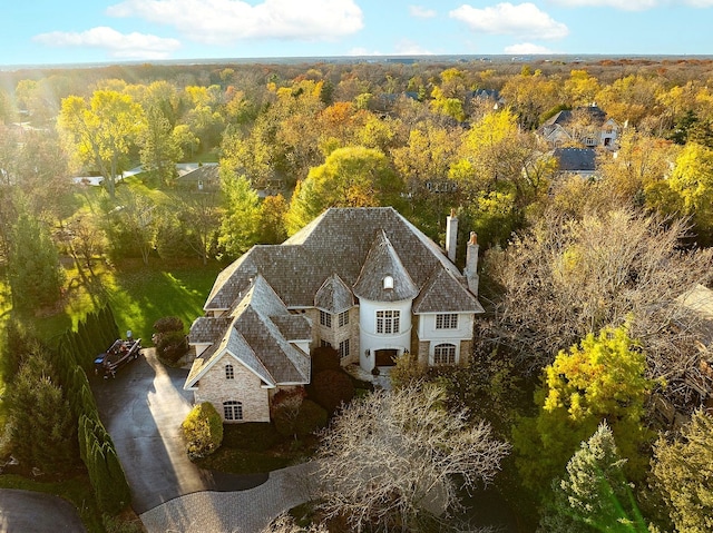 birds eye view of property with a forest view