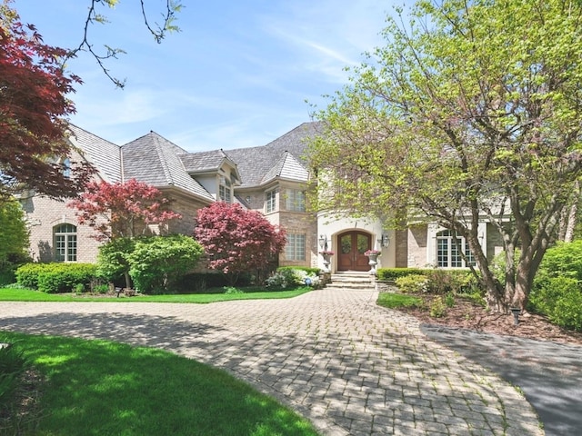 view of front of property with stone siding and french doors