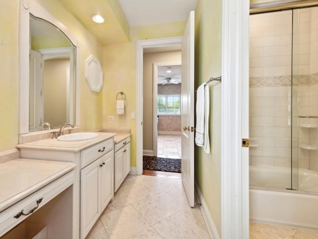 full bathroom featuring tile patterned flooring, baseboards, bath / shower combo with glass door, and vanity