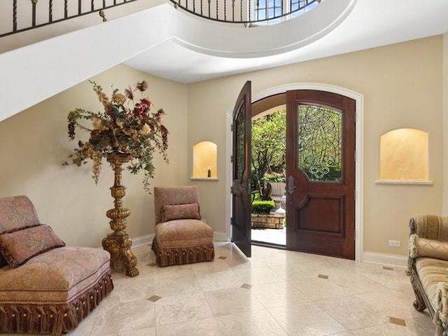 tiled foyer featuring baseboards