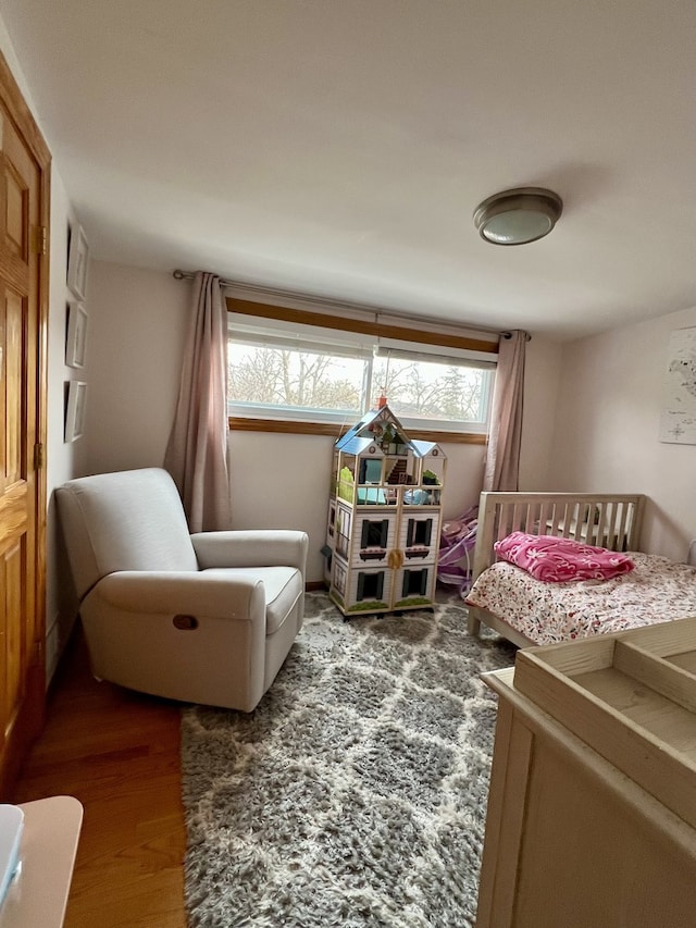 bedroom with dark hardwood / wood-style floors