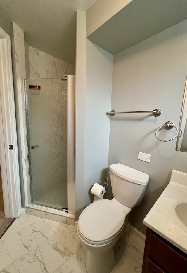 bathroom featuring vanity, toilet, and a shower with shower door