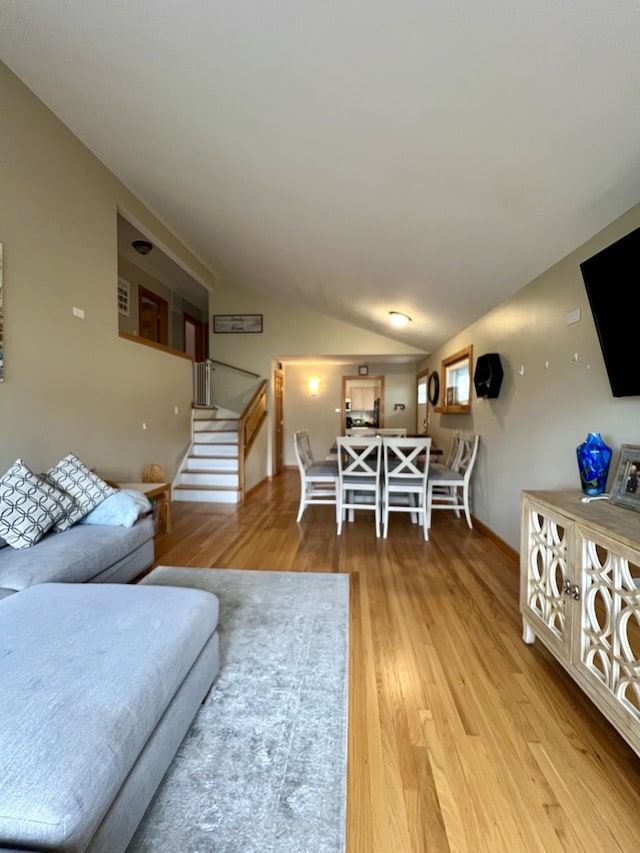 living room featuring hardwood / wood-style floors and lofted ceiling