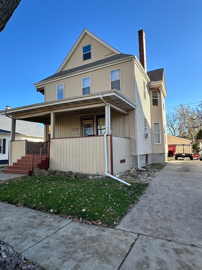 view of property exterior with covered porch