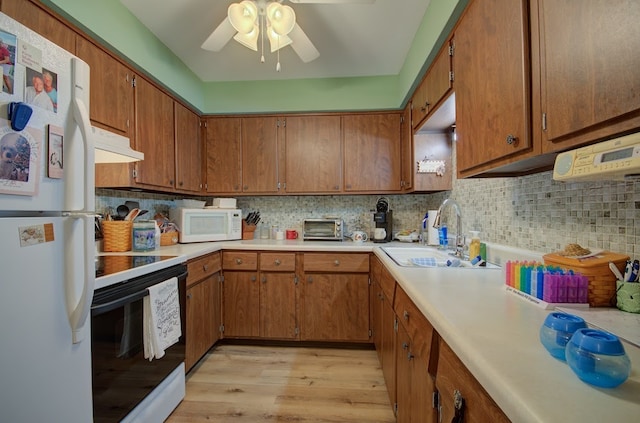 kitchen featuring backsplash, sink, white appliances, and light wood-type flooring