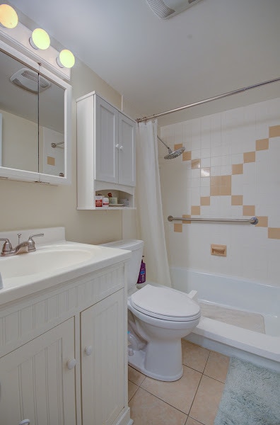 bathroom with tile patterned floors, vanity, and toilet