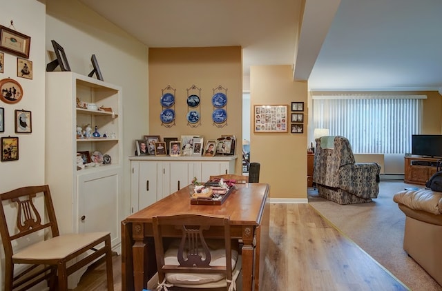 dining room featuring light hardwood / wood-style floors and a baseboard radiator