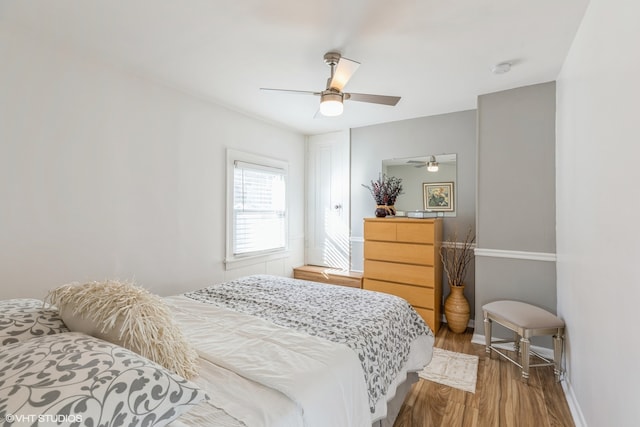 bedroom with hardwood / wood-style flooring and ceiling fan