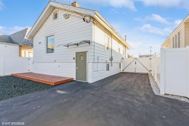 rear view of house with a wooden deck