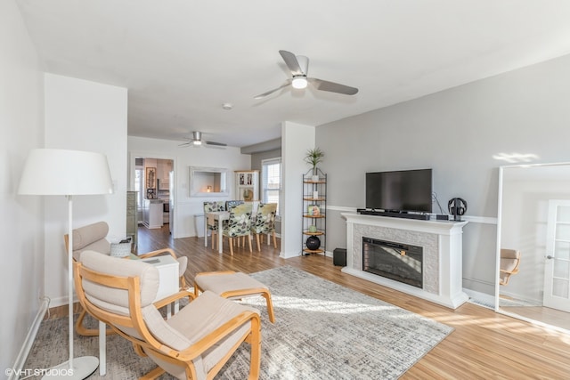 living room with ceiling fan and hardwood / wood-style flooring