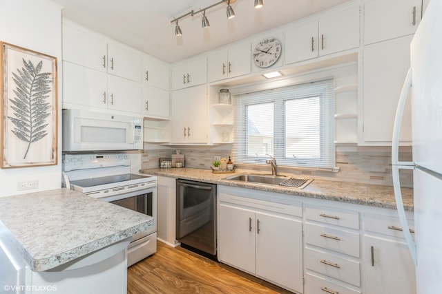 kitchen with sink, tasteful backsplash, light hardwood / wood-style flooring, white appliances, and white cabinets