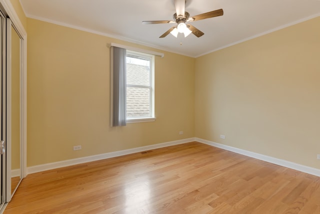 spare room featuring crown molding, light hardwood / wood-style flooring, and ceiling fan