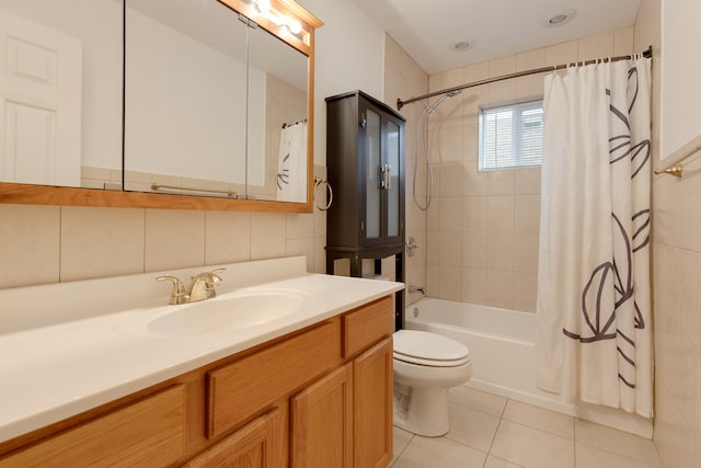 full bathroom featuring vanity, tile patterned floors, toilet, tile walls, and shower / tub combo